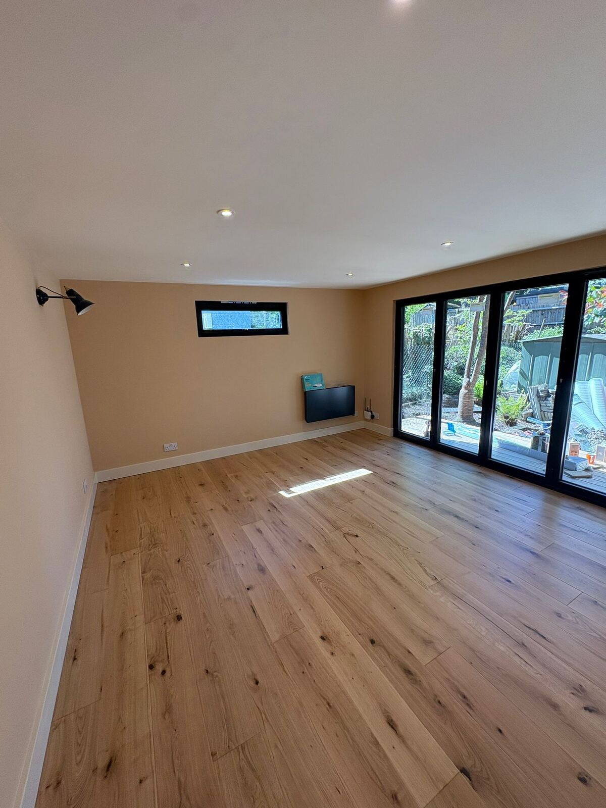 Garden room interior with bi-fold doors open to the garden